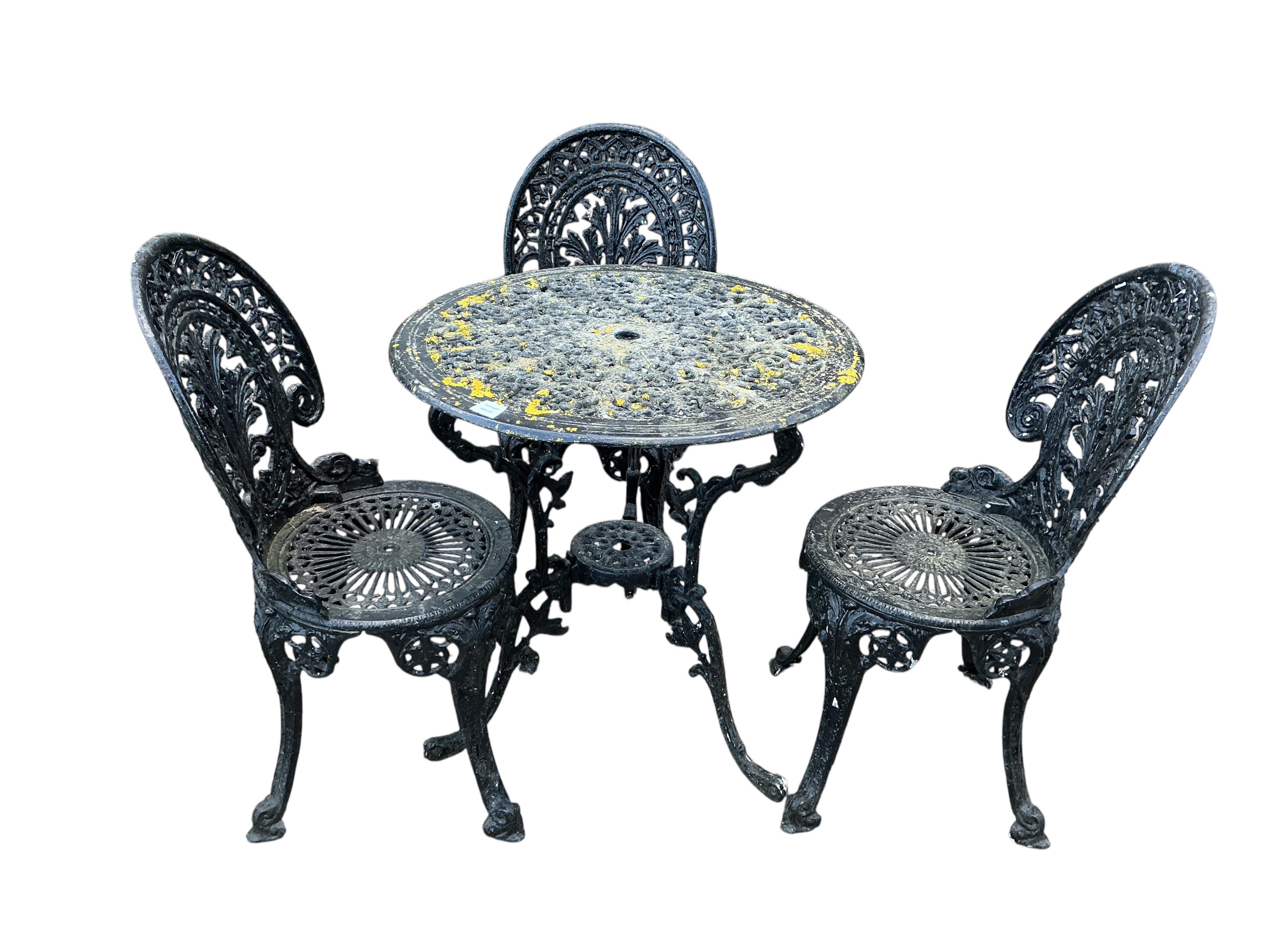 A Victorian style painted aluminium garden table, diameter 66cm and three chairs